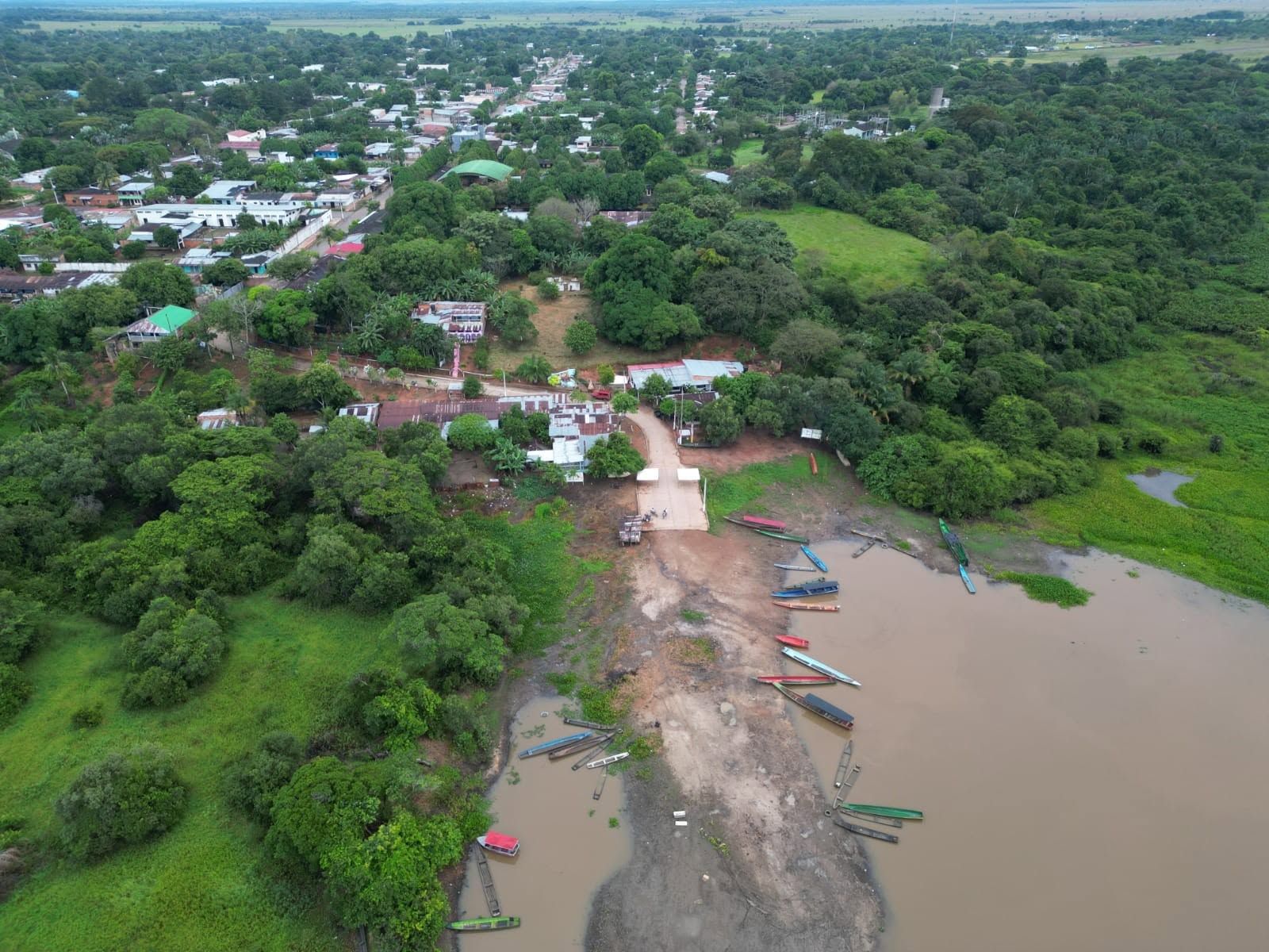 El pueblo y la laguna bajando en verano, desde lo alto: la orilla de arena y las canoas.